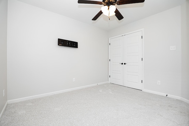 unfurnished bedroom with light colored carpet, ceiling fan, and a closet