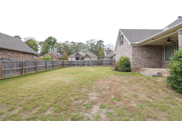 view of yard with ceiling fan and a patio