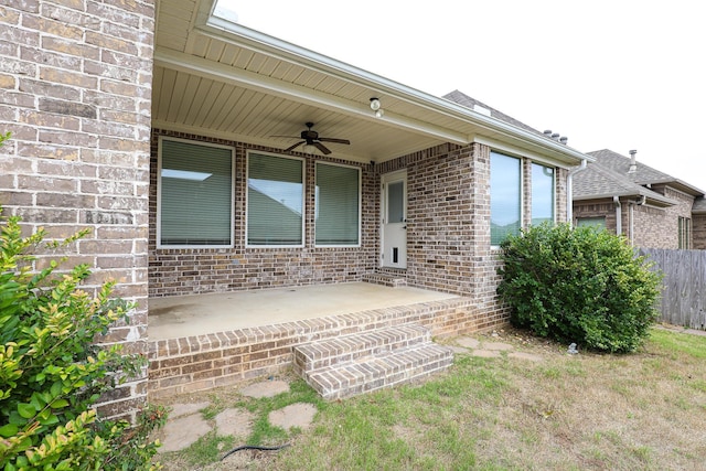 property entrance with ceiling fan and a patio