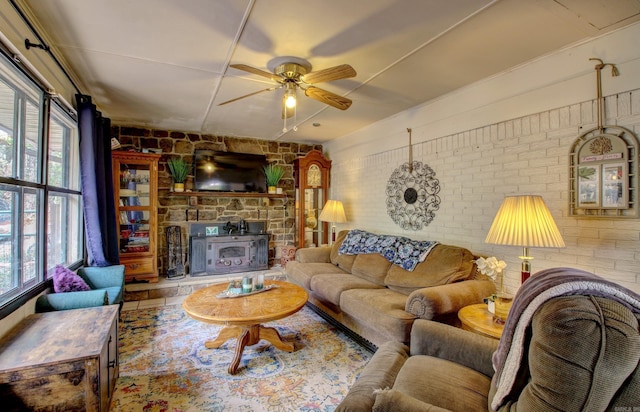 living room featuring ceiling fan and brick wall