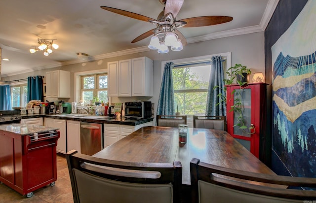 kitchen featuring light tile patterned flooring, white cabinetry, ceiling fan, stainless steel dishwasher, and crown molding