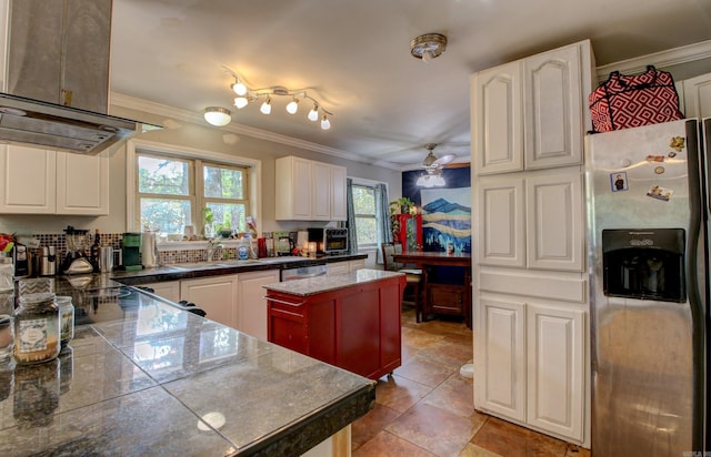 kitchen featuring ceiling fan, crown molding, island exhaust hood, a kitchen island, and appliances with stainless steel finishes