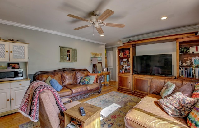 living room with light wood-type flooring, ceiling fan, and crown molding