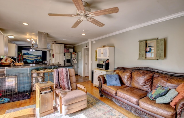 living room with ornamental molding, ceiling fan, and light hardwood / wood-style floors