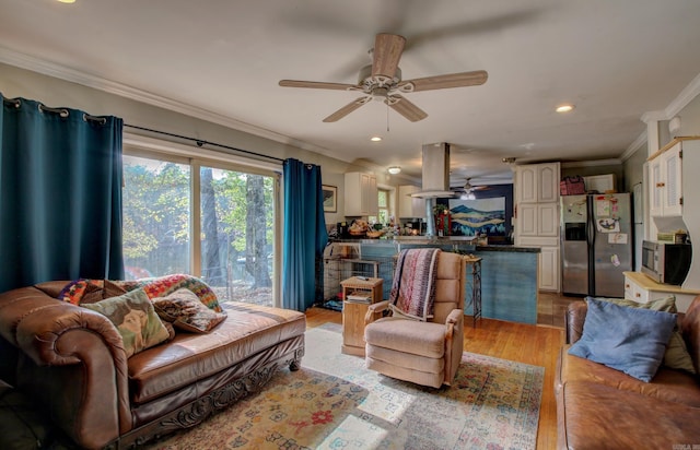 living room featuring light hardwood / wood-style flooring, ceiling fan, and crown molding