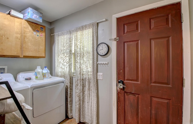 washroom with cabinets and washer and dryer