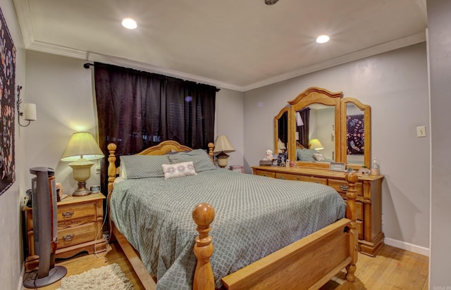 bedroom featuring light hardwood / wood-style floors and crown molding