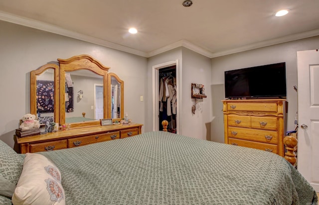 bedroom featuring a closet, a walk in closet, and crown molding