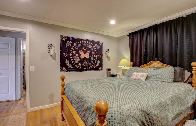 bedroom with light hardwood / wood-style flooring and ornamental molding