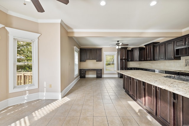 kitchen with light stone countertops, decorative backsplash, dark brown cabinets, and light tile patterned flooring