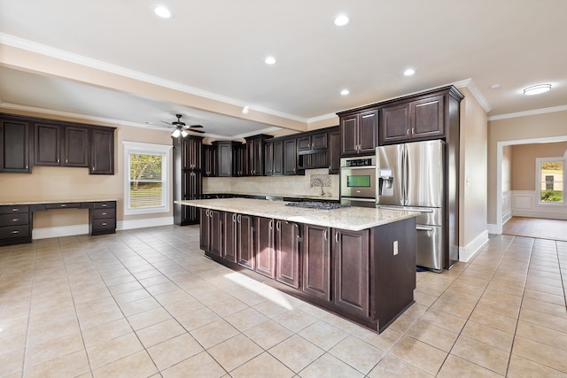 kitchen featuring dark brown cabinets, crown molding, a kitchen island, and stainless steel fridge