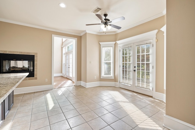 interior space featuring ceiling fan, french doors, light tile patterned floors, and ornamental molding