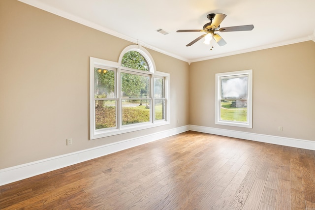 empty room featuring hardwood / wood-style floors, ceiling fan, and crown molding