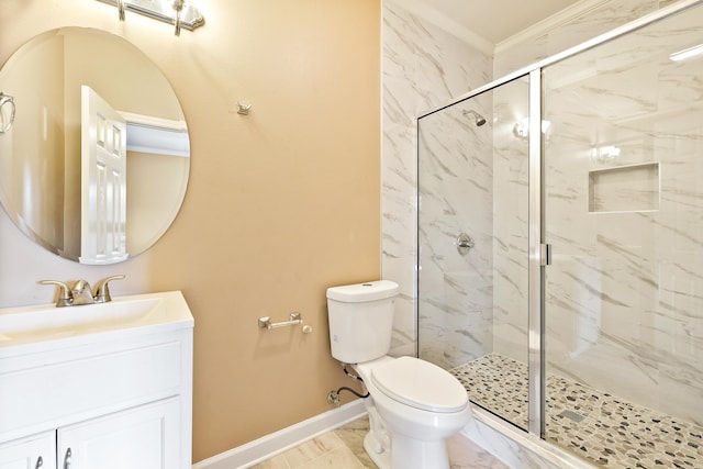 bathroom featuring ornamental molding, vanity, toilet, and a shower with door