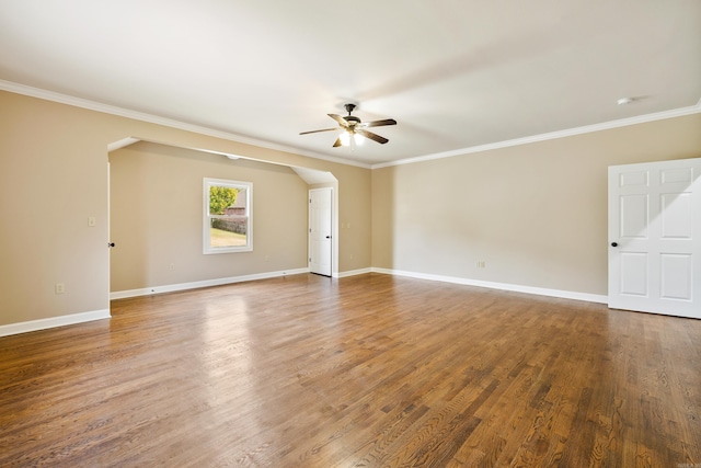 empty room with ceiling fan, wood-type flooring, and ornamental molding