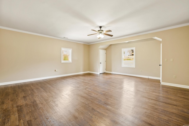 unfurnished room with crown molding, dark hardwood / wood-style floors, and plenty of natural light