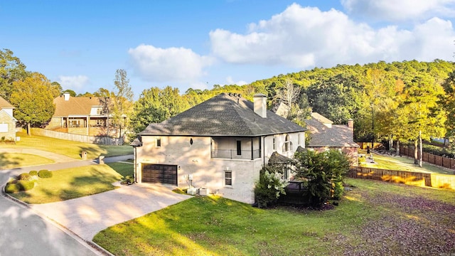 view of home's exterior with a lawn and a garage