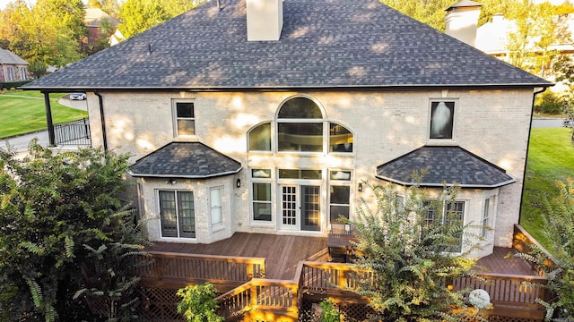 rear view of house featuring a wooden deck