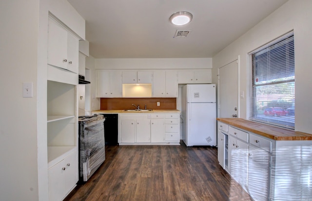 kitchen with white cabinetry, white refrigerator, range, sink, and dark wood-type flooring