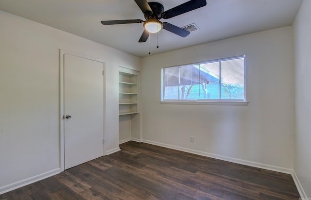 unfurnished bedroom with ceiling fan and dark hardwood / wood-style flooring