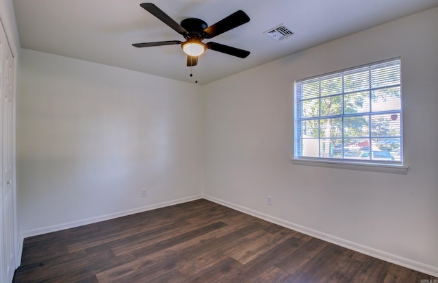 spare room featuring dark hardwood / wood-style flooring and ceiling fan