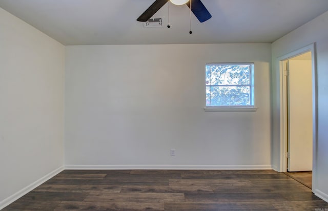 spare room with dark hardwood / wood-style flooring and ceiling fan