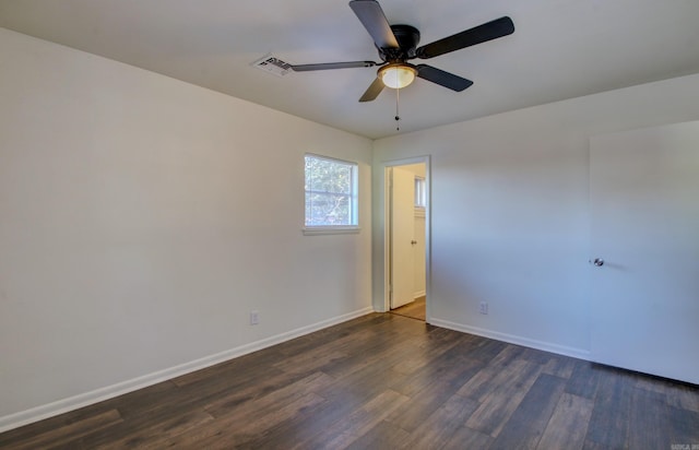 empty room featuring ceiling fan and dark hardwood / wood-style floors