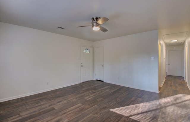 spare room featuring dark wood-type flooring and ceiling fan