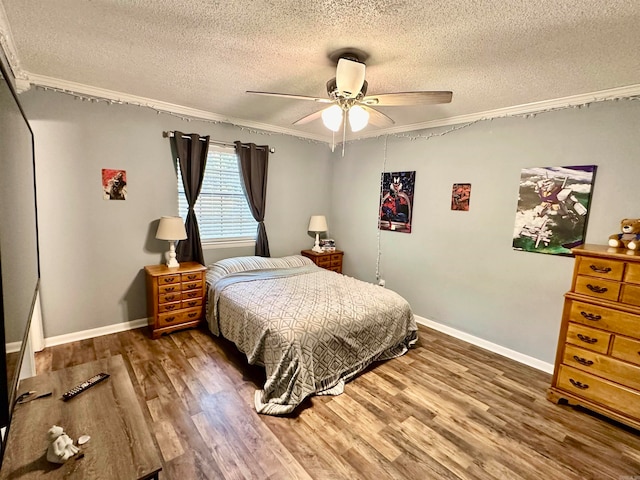 bedroom with hardwood / wood-style flooring, ceiling fan, a textured ceiling, and ornamental molding