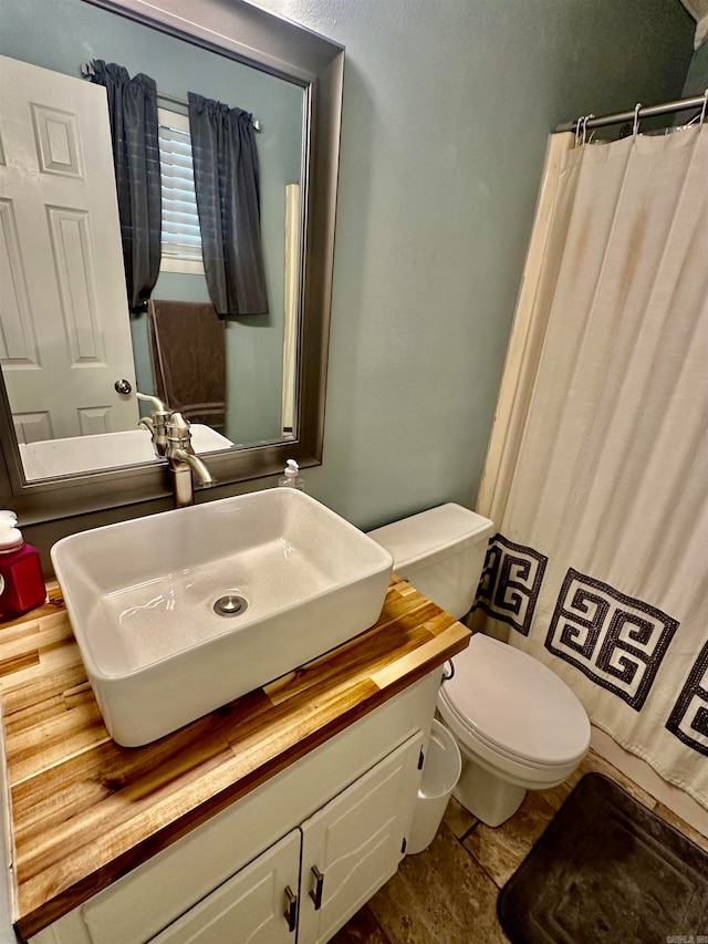 bathroom featuring toilet and vanity