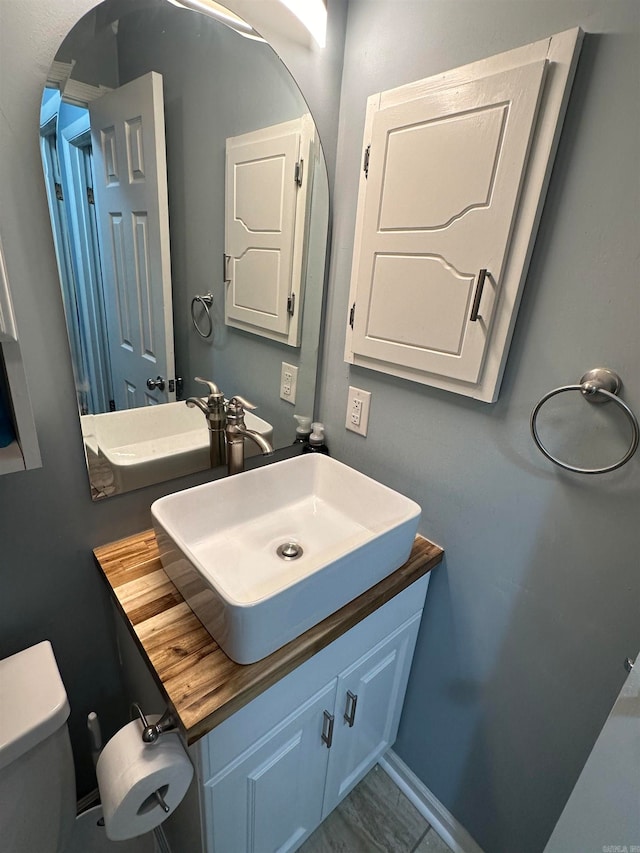 bathroom with toilet and vanity