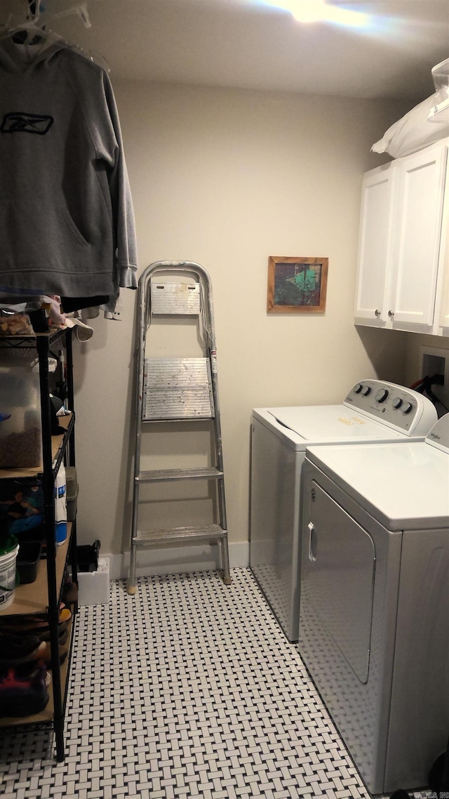 laundry room featuring cabinets and washing machine and dryer