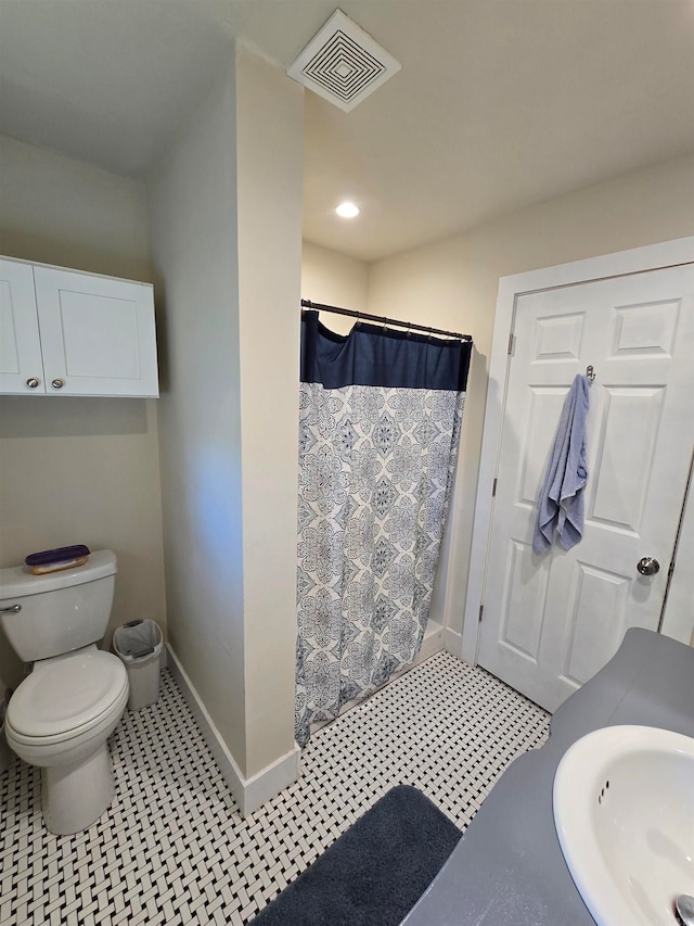 bathroom with tile patterned flooring, a shower with curtain, toilet, and sink