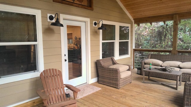 wooden deck with an outdoor living space