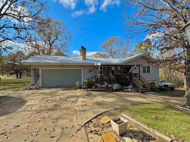 single story home featuring a garage and covered porch