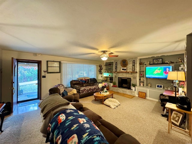 carpeted living room featuring a brick fireplace, ceiling fan, and built in features