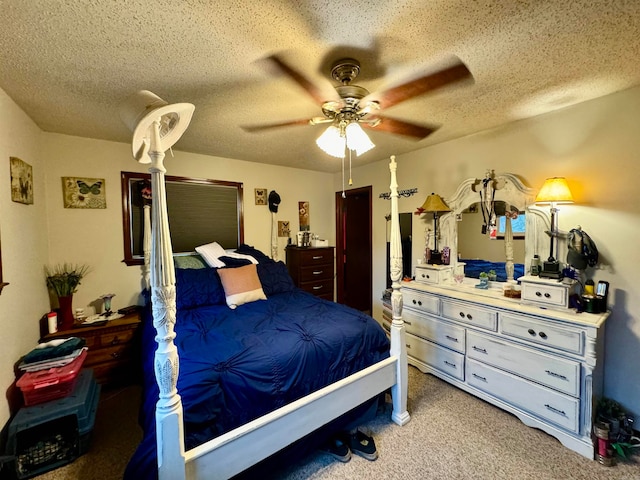 carpeted bedroom with ceiling fan and a textured ceiling