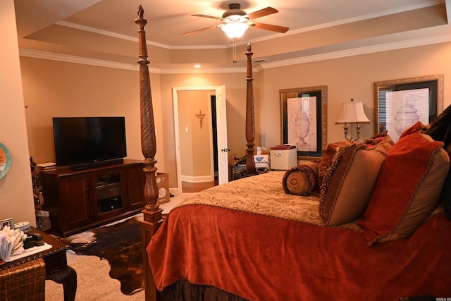 bedroom with ceiling fan, a raised ceiling, carpet floors, and ornamental molding