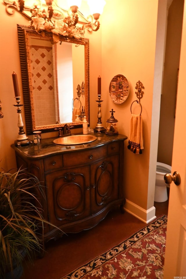 bathroom featuring tile patterned floors, vanity, and toilet