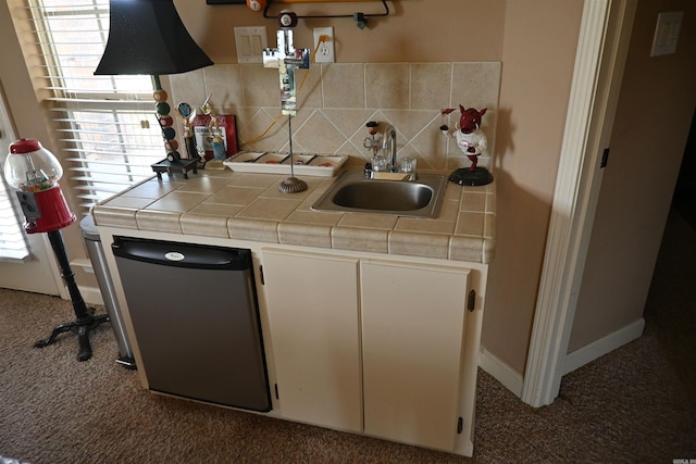 kitchen featuring dishwasher, tile counters, and plenty of natural light