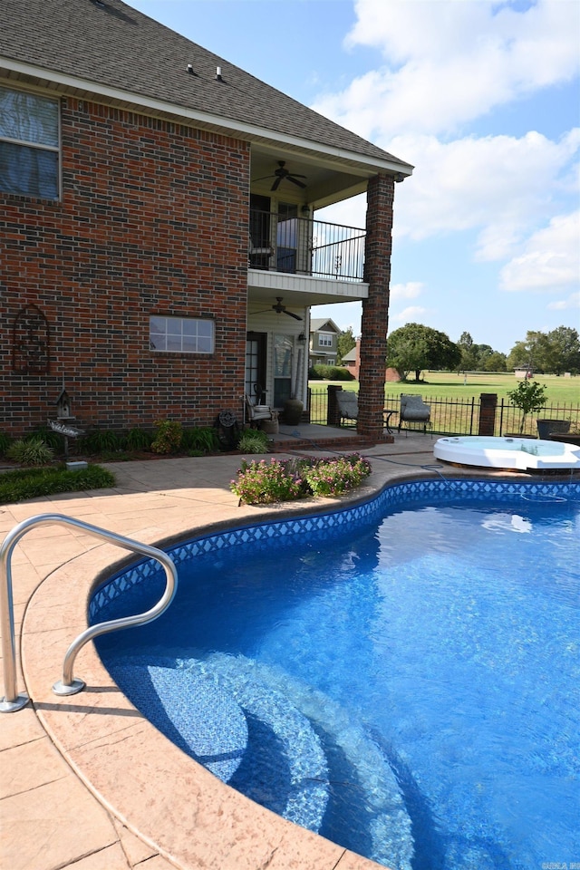 view of swimming pool with ceiling fan and a patio area