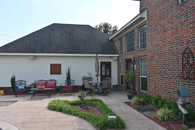 rear view of house with a patio and an outdoor hangout area