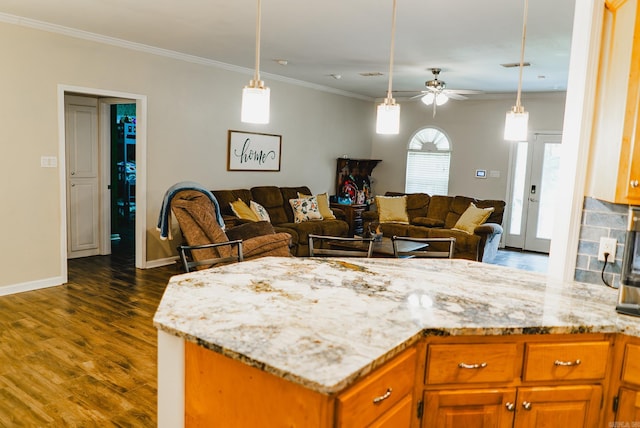 kitchen featuring ornamental molding, pendant lighting, dark hardwood / wood-style floors, and ceiling fan