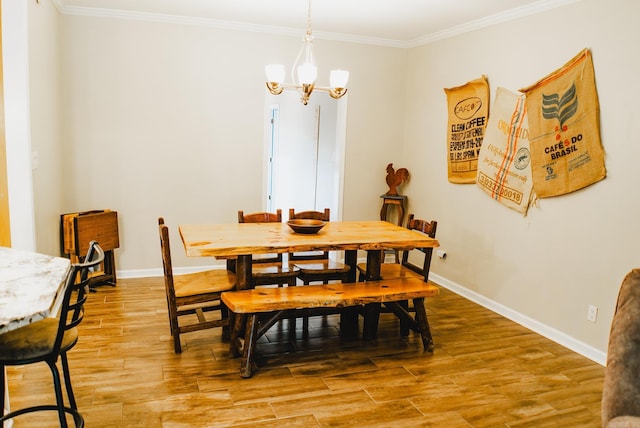 dining area featuring an inviting chandelier, hardwood / wood-style floors, and ornamental molding