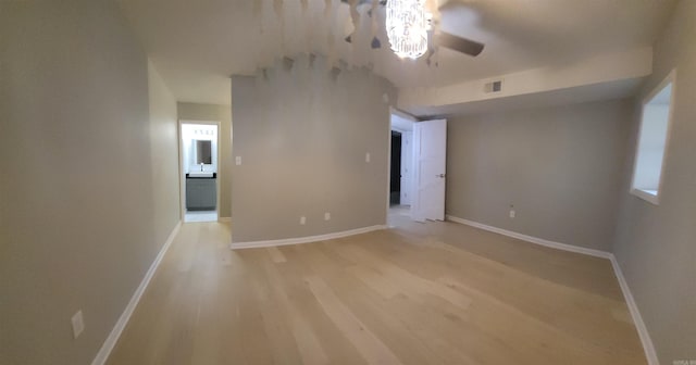 empty room featuring ceiling fan and light wood-type flooring