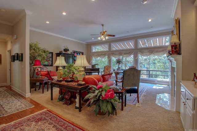 carpeted living room with ornamental molding and ceiling fan