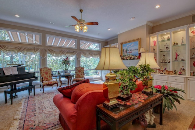 living room featuring ornamental molding, light carpet, and ceiling fan