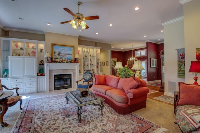 carpeted living room with a fireplace, ceiling fan, and crown molding