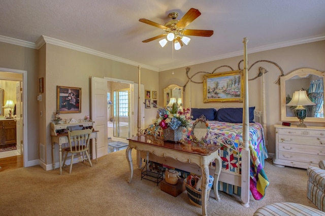 carpeted bedroom featuring ensuite bathroom, ceiling fan, and crown molding