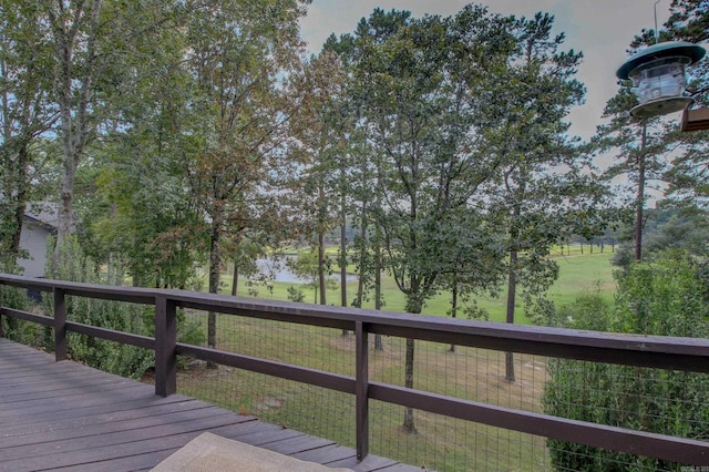 wooden terrace featuring a lawn